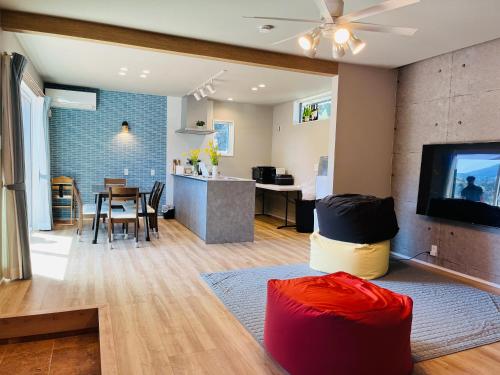 a living room with a kitchen and a dining room at 村の小さなお宿　おきな in Tosa