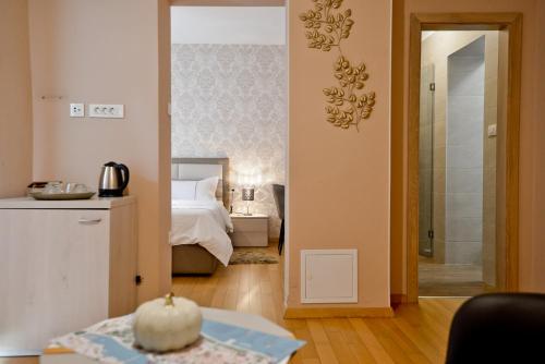 a bedroom with a bed and a bathroom at Zoilo Rooms self check-in in Zadar