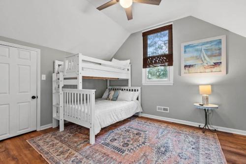 a bedroom with a white bunk bed and a rug at Pawleys Island Retreat 4 Bedroom Haven in Pawleys Island