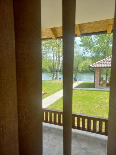 a view from a porch with a view of a park at Drinsko Srce in Ljubovija
