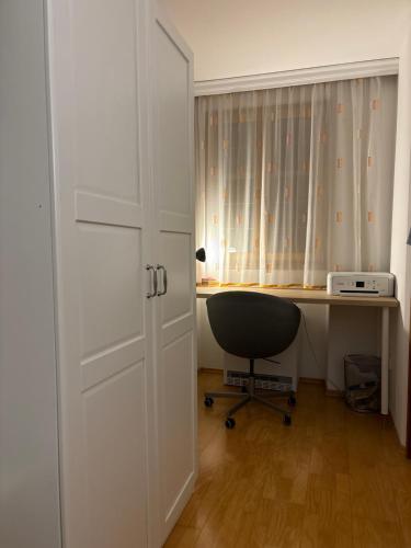 an office with a desk and a chair next to a door at Nice Room in City Centre in Hall in Tirol