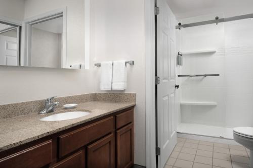 a bathroom with a sink and a toilet at Residence Inn Kansas City Overland Park in Overland Park