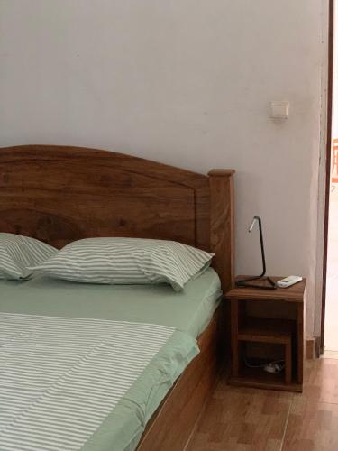 a bedroom with a bed and a lamp on a night stand at Studio Salam in Ziguinchor