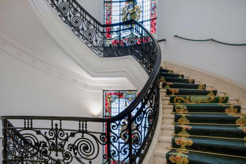 a staircase with stained glass windows in a building at Hotel Palacio del Retiro, Autograph Collection in Madrid