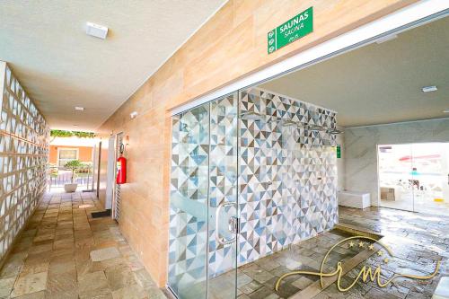 a building with a tile wall in a hallway at diRoma Fiori RM Hospedagem in Caldas Novas