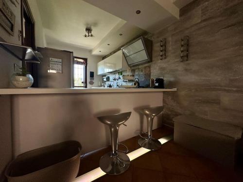 a bar with stools and a counter in a room at Casa Cecilia(Villino da 2 a 8 persone) in Ladispoli