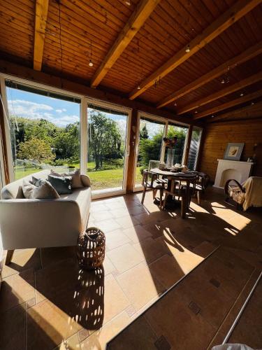 a large room with a bed and a table at Kuća Šuma in Velika Buna
