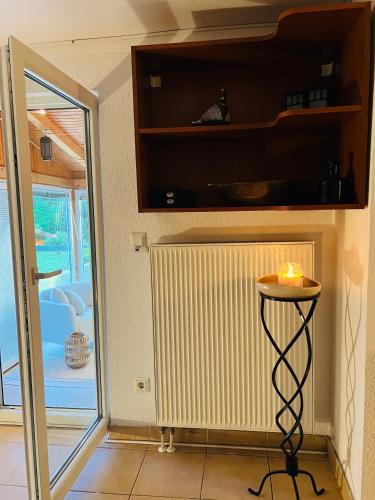 a room with a table with a candle on it at Kuća Šuma in Velika Buna