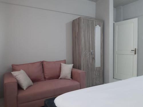 a living room with a couch and a mirror at The Alpha* residence in Tema