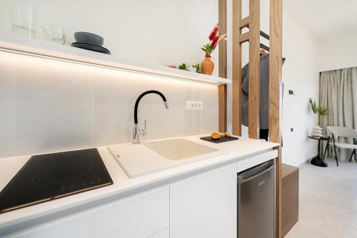 a kitchen with a sink and a counter top at Little Corfu in Dassia