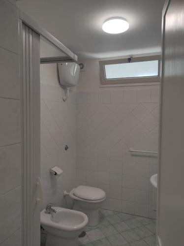a bathroom with a toilet and a sink at SUITE HOME VIA ROMA in SantʼAntonio Abate
