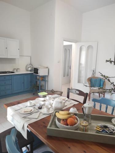 a kitchen with a table with a tray of fruit on it at SUITE HOME VIA ROMA in SantʼAntonio Abate