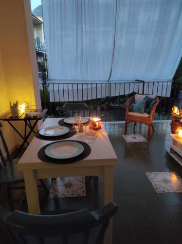 a table with plates and candles on it in a living room at SUITE HOME VIA ROMA in SantʼAntonio Abate