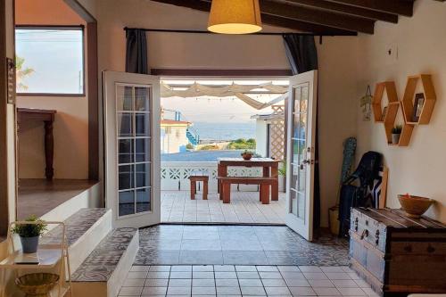 an open door to a patio with a view of the ocean at CASA SURF - BEACHFRONT LIVING in Ensenada