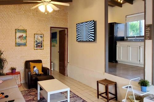 a living room with a couch and a ceiling fan at CASA SURF - BEACHFRONT LIVING in Ensenada