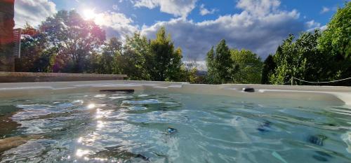 a hot tub in a backyard with trees in the background at Alma Invicta Padrões I ( w/ Private Swimming Pool) in Montalegre