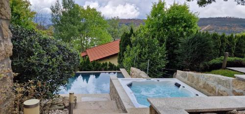 a swimming pool in a garden with a swimming pool at Alma Invicta Padrões I ( w/ Private Swimming Pool) in Montalegre