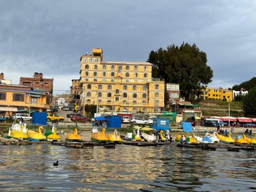 a group of small boats sitting in the water at HOTEL MIRADOR AL TITICACA in Copacabana