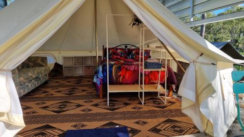 a room with a tent with a bed in it at Linga Longa Spiritual Retreat in Curra