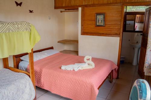 Un niño pequeño en una cama en un dormitorio en Cabañas Anzu, en Santa Clara