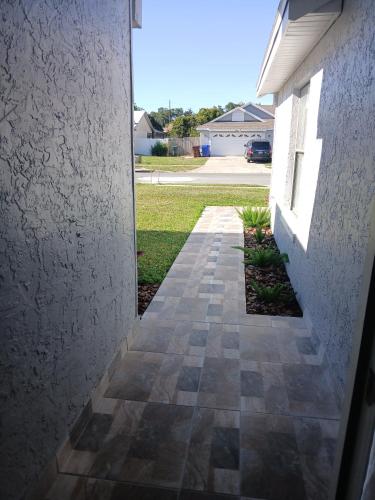 a walkway leading to the front door of a house at Nard Jolie Kay in Kissimmee