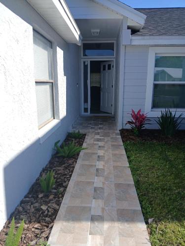 a house with a walkway leading to the front door at Nard Jolie Kay in Kissimmee