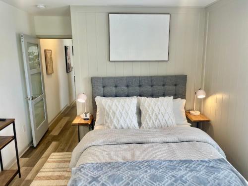 a bedroom with a bed with a blue comforter at Modern Fully Renovated Suite & Loft in Downtown Trenton in Trenton
