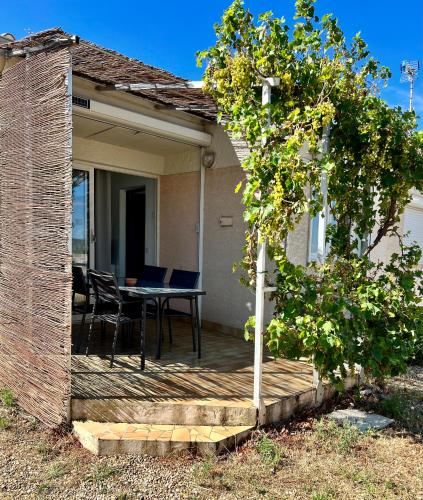 un patio avec une table et des chaises dessus dans l'établissement Maison de vacances à la plage, à Frontignan