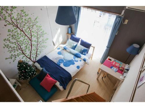 a small bedroom with a bed and a tree at Maison Cresta Urayasu - Vacation STAY 11150 in Urayasu