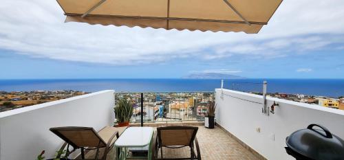 a balcony with chairs and a view of the ocean at Casinha Nova - Comfort & Class in Fogo in São Filipe