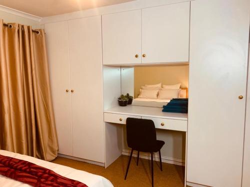 a bedroom with a bed and a desk with a chair at Afrikawisa@Rosebank in Johannesburg