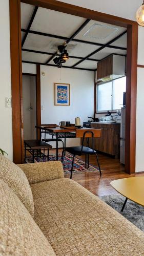 a living room with a table and a kitchen at Animal Art Apartment Type 21 in Ogikubo