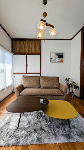 a living room with a couch and a table at Animal Art Apartment Type 21 in Ogikubo