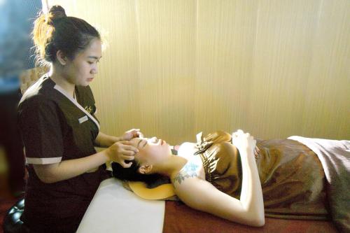 a girl getting her hair brushed by a woman at Hotel Hải Châu in Chau Doc