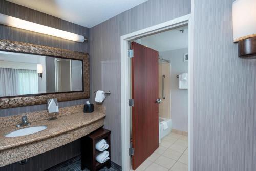 a bathroom with a sink and a mirror at Courtyard Bangor in Bangor