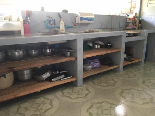 a kitchen counter with lots of pots and pans at The Jeffy Pool Villa in Chanthaburi