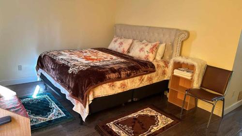 a bedroom with a bed and a chair at Divine Villa and Resorts 67 Sherman 5mins to EWR Airport and 4mins to Penn Station Newark, 20Mins to New York in Newark