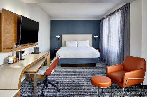 a hotel room with a bed and a desk at Courtyard by Marriott Nashville Downtown in Nashville