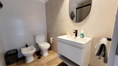 ein Badezimmer mit einem WC, einem Waschbecken und einem Spiegel in der Unterkunft Hermoso apartamento con terraza! Punta Carretas in Montevideo