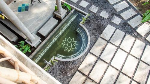 an overhead view of a pool of water with a flower in it at Baia Nest Main House Self Service BNB Near the Beach in Gubat