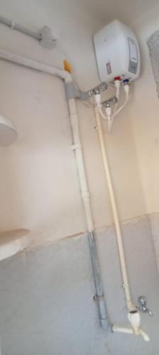 a bathroom with a camera on the wall at Hallima Residency Non Ac in Pudukkottai