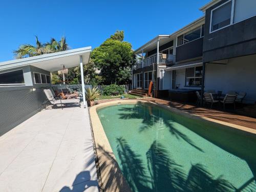 a swimming pool in front of a house at Luxury oasis resort Pet friendly apartment with private pool and spa in Port Macquarie