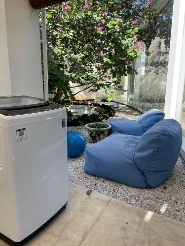 a blue bean bag chair sitting next to a refrigerator at New Kuta Suites in Jimbaran