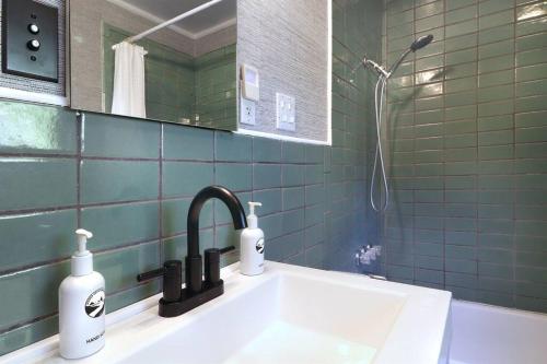 a bathroom sink with two soap bottles on it at Sonoma Coast River Retreat for 6 Whole House in Jenner