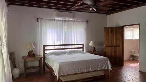 a bedroom with a large bed and a window at Casa Moes in Cahuita