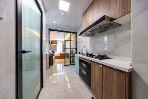 a kitchen with wooden cabinets and a counter top at Boruisi Video and Audio Light House - Shenzhen Convention and Exhibition Center Gangxia Metro Station in Shenzhen