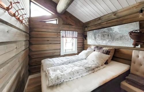 a bedroom with a bed in a wooden cabin at Gorgeous Home In Vossestrand With House A Mountain View in Vossestrand
