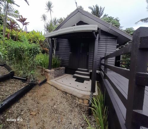 a small building with a door and a porch at Kaila Na Ua Resort in Korotogo