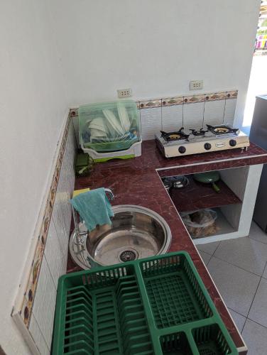 a kitchen with a sink with green baskets in it at Green House Boracay in Boracay