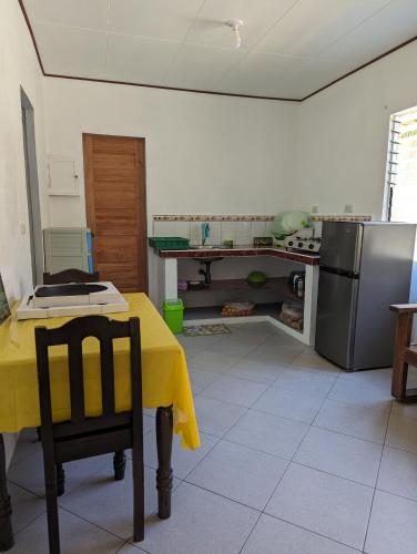 a kitchen with a table with a yellow table cloth at Green House Boracay in Boracay